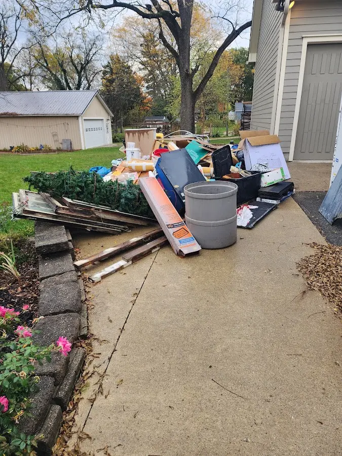Dumpster being loaded with debris for 12 Yard Dumpster Rental in The Dalles